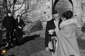 At Castello di Castel d'Ario, Mantua, Italy, just before the ceremony, the bride tenderly wipes a tear from the groom’s cheek. Captured in black and white, the scene radiates deep love and tenderness.